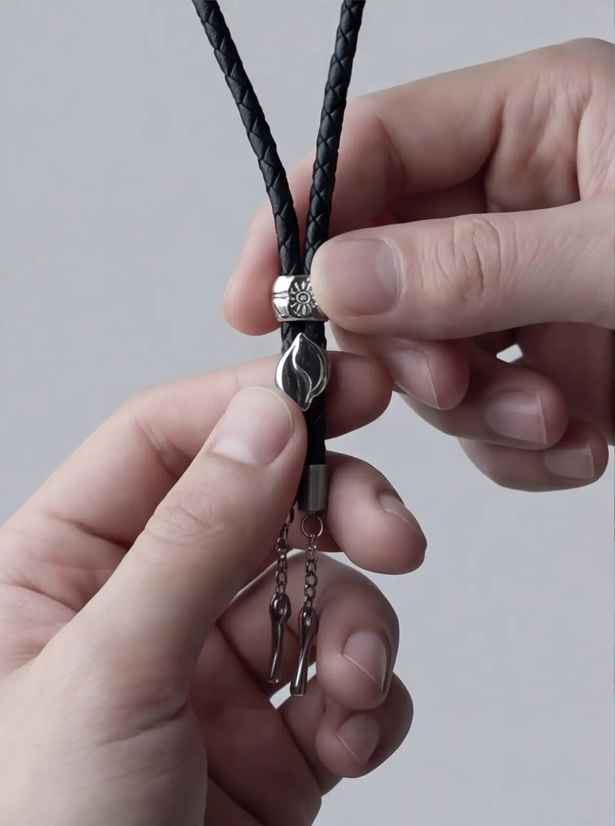 Hands adjusting the cord show a real wearing gesture.