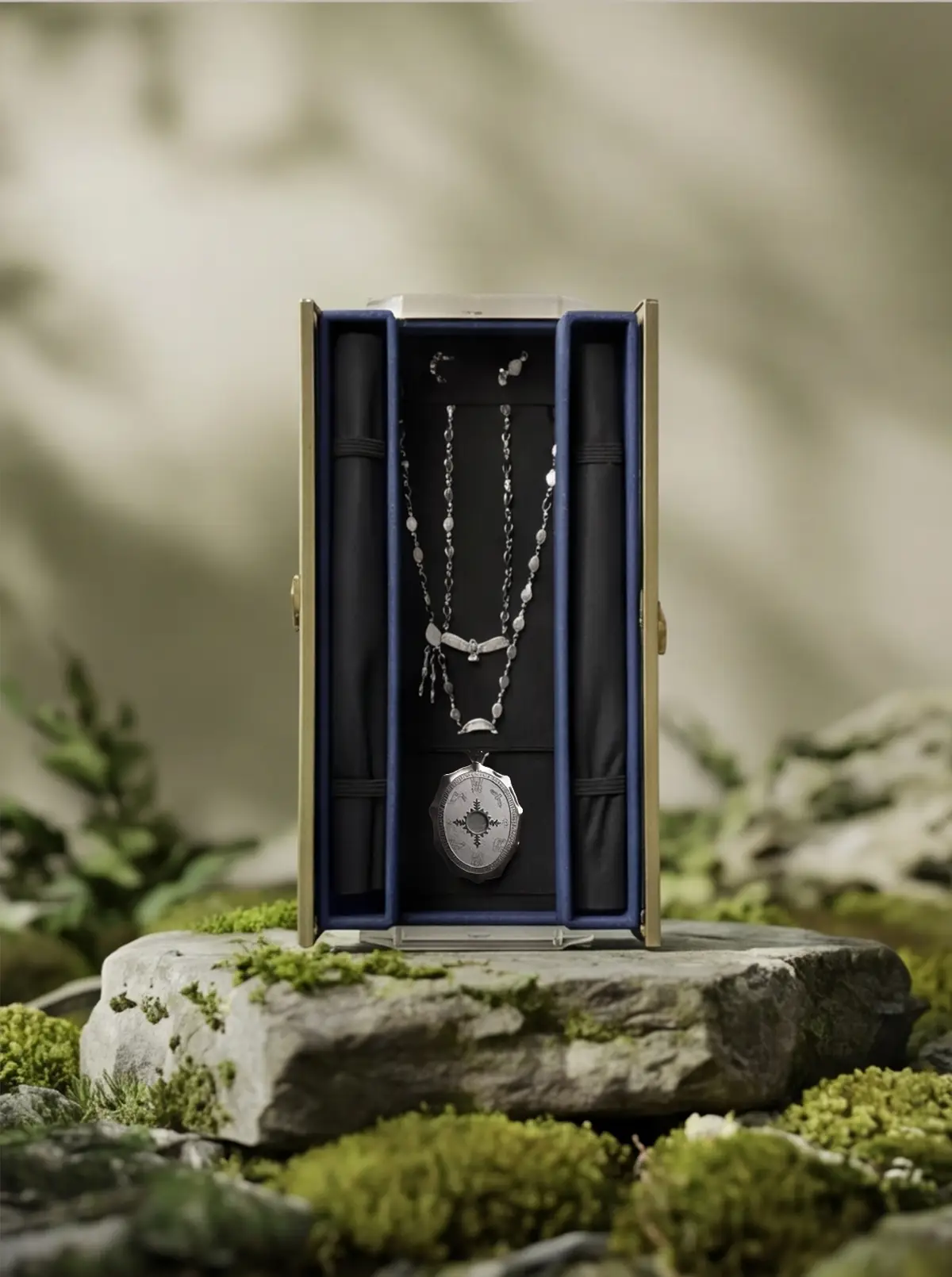 Moss and stone reconnect the case to natural material storytelling.